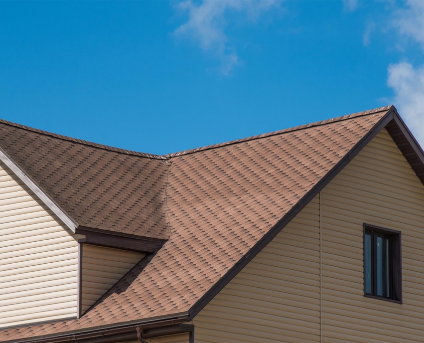 Side View Of A Residential Roof With Brown Asphalt Shingles