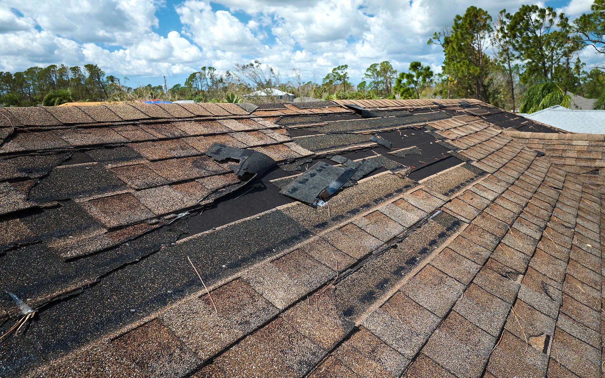 Side View Of A Roof With Damaged Shingles