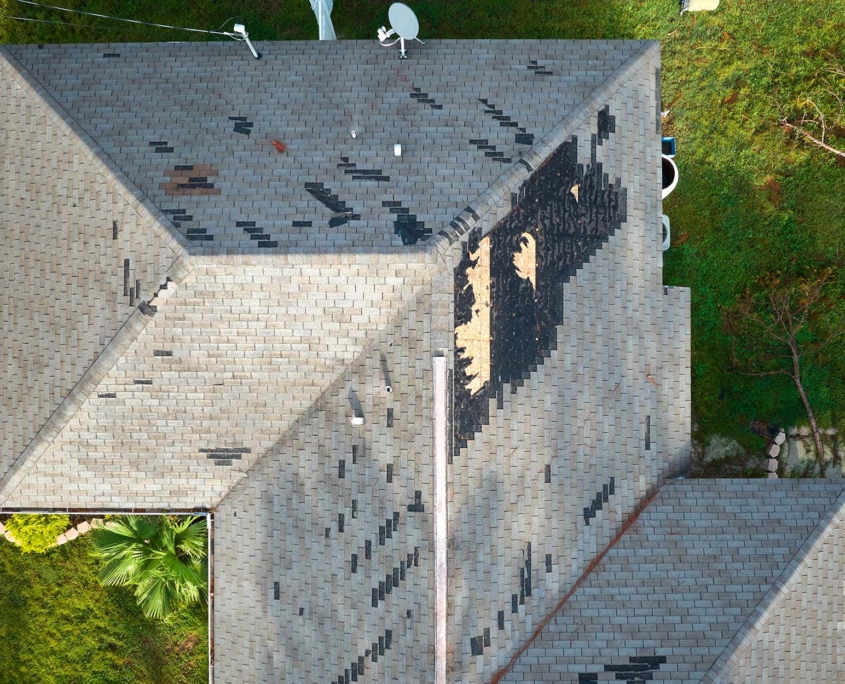 Damaged House Roof With Missing Shingles After Hurricane Ian In Florida