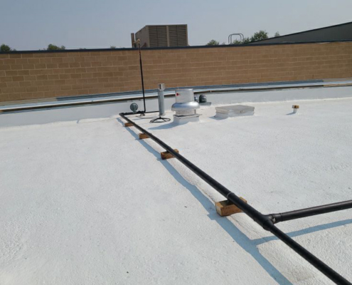 White Commercial Roof Side View With Piping