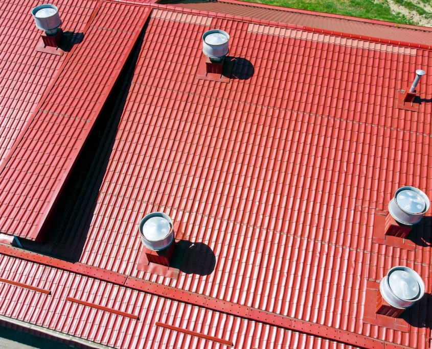New Red Metal Warehouse Roof With Installed Pipes Of Ventilation Systems
